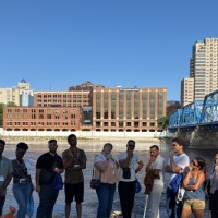 Group of students posing near Blue Bridge thinking